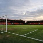 An empty pitch of bournemouth's vitality stadium with just one goal visible and no writing on the stands