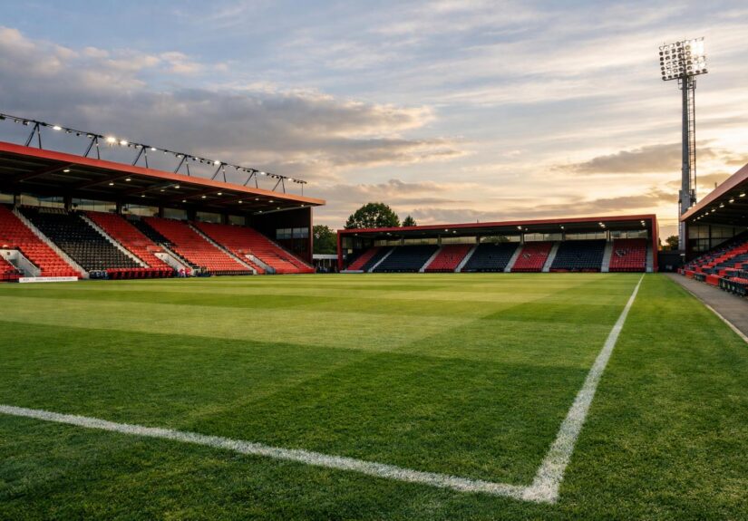 An empty pitch of Bournemouth's stadium with no writing on the stands, remove the goal from the side of the pitch